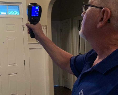 Bob, Owner and Inspector checking door using infrared imaging device